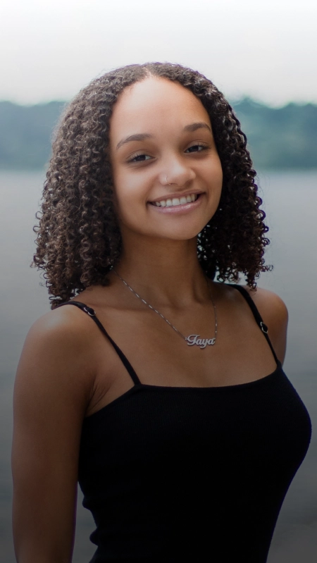 A young woman smiling confidently with straight teeth from clear aligners in Plantation.