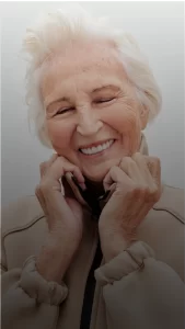 A mature woman smiling after restorative dentistry treatment in Plantation.