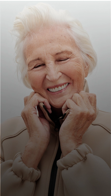 A mature woman smiling after restorative dentistry treatment in Plantation.
