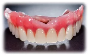 An upper denture against a black backgound.