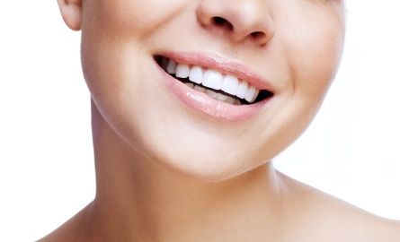 A young woman smiling confidently after teeth whitening treatments.